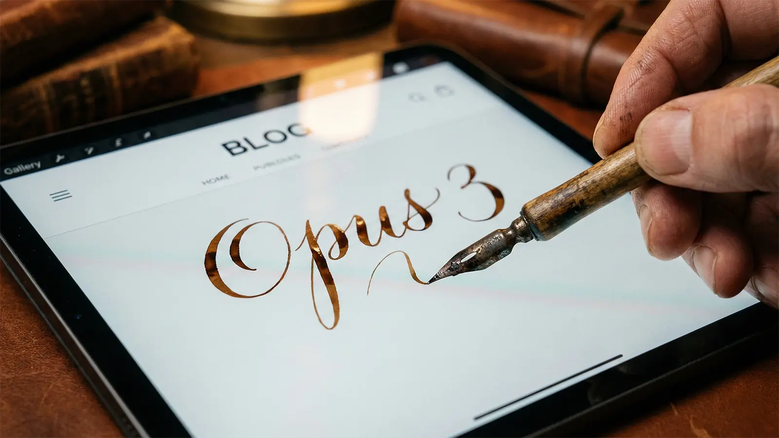 Ein Schriftsteller schreibt mit einer Feder in Schreibschrift das Wort "OPUS 3" in einen Blog.